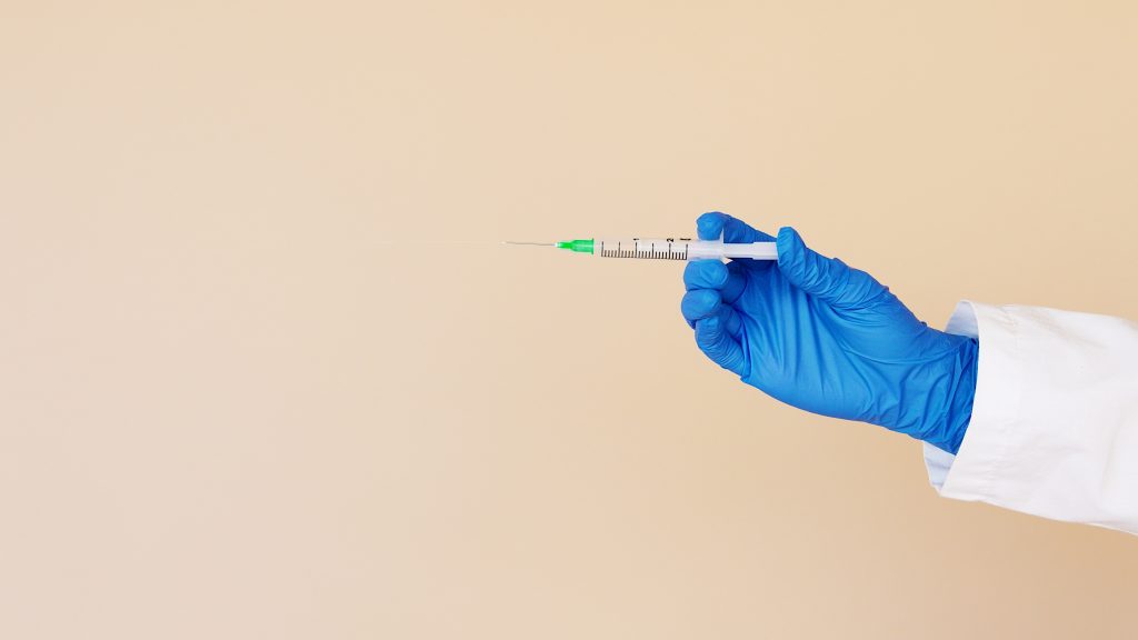 gloved-hand-holding-syringe