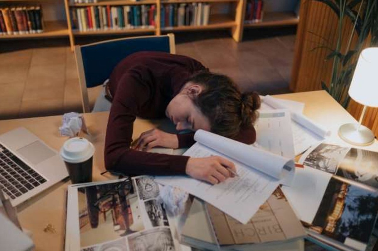 girl-asleep-on-books-studying