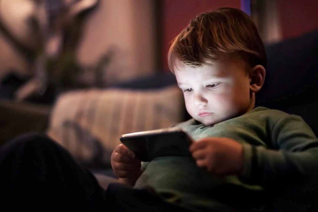 young-child-using-phone-on-couch