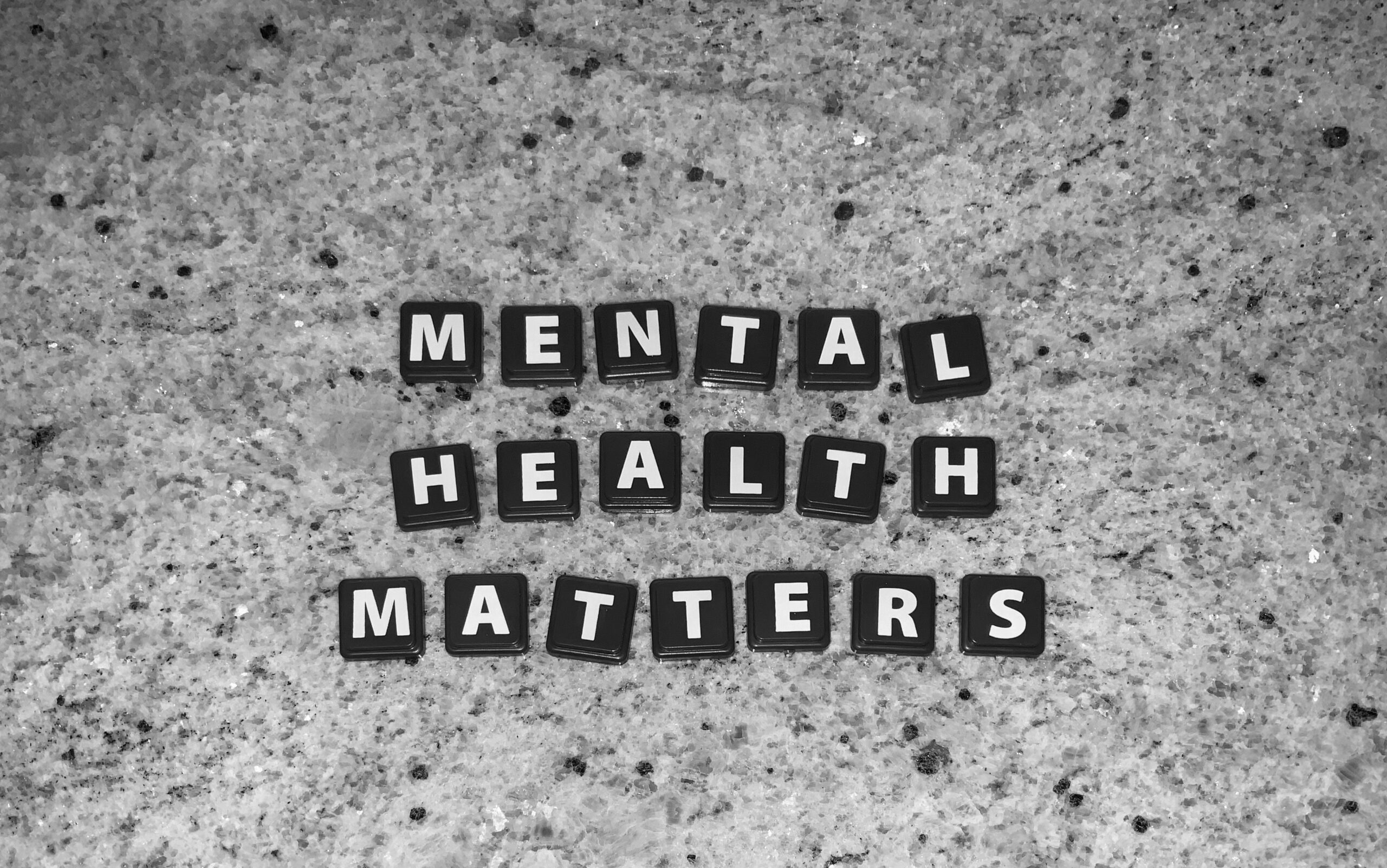 black-and-white-tiles-spelling-out-mental-health-matters-on-grey-marble-surface
