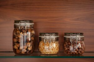 three-glass-jars-with-dried-figs-corn-and-hazelnuts
