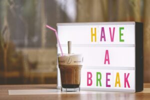 glass-of-coffee-with-straw-and-sign-board-with-have-a-break-text