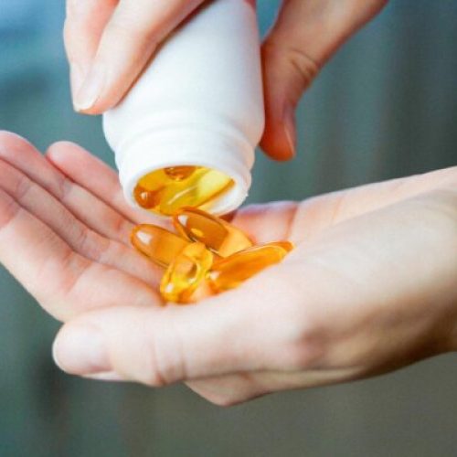 pouring vitamin pills on palm