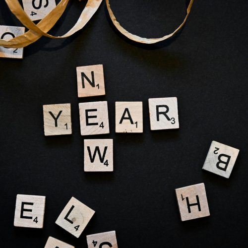new year spelled out in tiles on black background