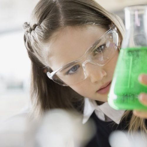 school-girl-examining-liquid-in-beaker-490635033-5889093e3df78caebc8978b1